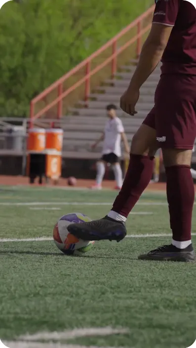 Soccer player about to strike the ball on a turf field